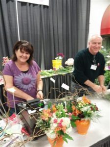 Jeanna Furst, AIFD, and Michael Brown, AIFD, ringing up the flower sales
